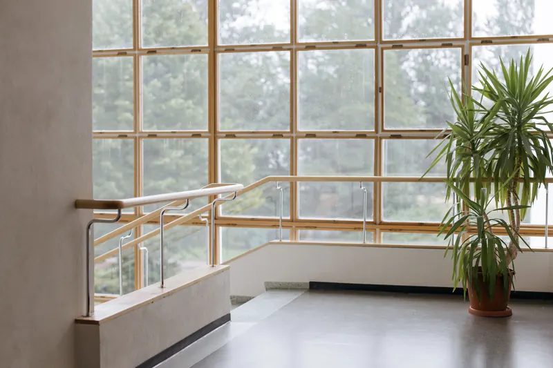 Glass stair railing in front of a large window wall