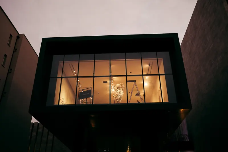 Lit glass facade of a modern building at dusk